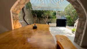 a large wooden table in a room with a window at Holiday Home Traum in Krk