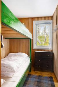 a bunk bed in a room with a window at Åstin in Dirdal