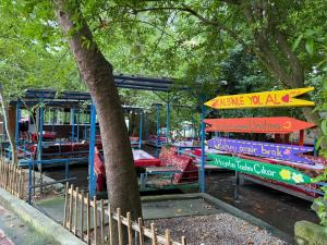 a park with a playground with beds and a tree at Selale Cennet Evleri in Kemer +24 photos