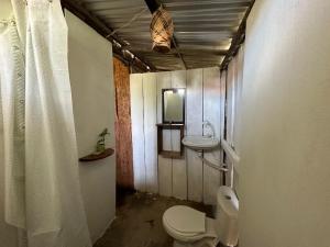 a bathroom with a toilet and a sink at Waikiki Pacific Hostel in Buenaventura