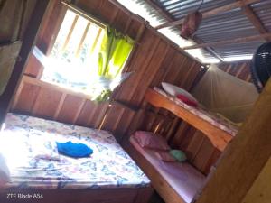 a room with two bunk beds and a window at Waikiki Pacific Hostel in Buenaventura