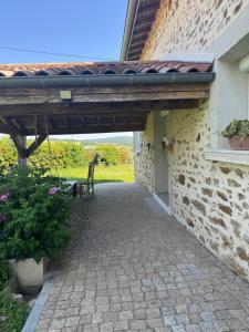 a patio outside of a building with a bench at Maison L'étalonblanc in Tupin-et-Semons +3 photos