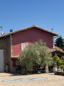 a red house with a tree in front of it at Maison L'étalonblanc in Tupin-et-Semons
