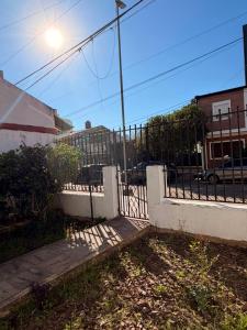 a wrought iron fence with a gate on a street at Casa Morotï - Casa de dos habitaciones en la Costanera de Corrientes in Corrientes