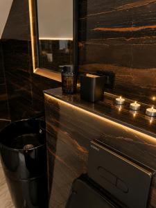 a bathroom with a counter with candles and a toilet at Maison Royale in Otopeni +28 photos