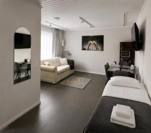 a living room with two beds and a couch at ARINA Toivakka in Toivakka