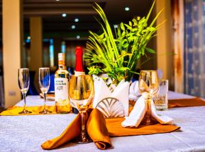 a table with wine bottles and wine glasses on it at Armaflex hotel SMC LTD in Lira +2 photos