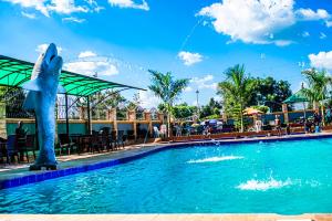 a dolphin statue in a pool at a resort at Armaflex hotel SMC LTD in Lira