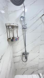 a shower in a bathroom with white marble walls at Mahalla Old City Samarkand in Samarkand +88 photos