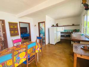 a kitchen and dining room with a table and chairs at Macondo GuestHouse Beach in Playa Estacahuite +24 photos