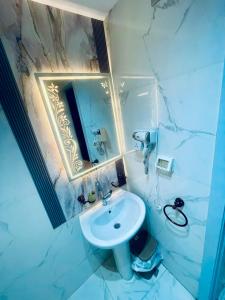 a bathroom with a white sink and a mirror at lotus view El tahrir in Cairo +72 photos