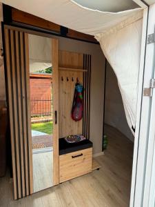a room with a door open to a room with a bed at Glamping Bieszczadzki Amor in Zawóz