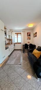 a kitchen and living room with a couch and a table at GADD Ferienwohnung 004 Glück an der Donau I Best Prestige Stay 24 h Check-In in Straubing +34 photos