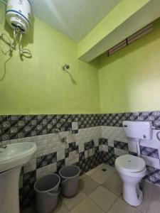 a bathroom with a toilet and a sink at North Queen Homestay in Darjeeling