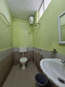 a bathroom with a toilet and a sink at North Queen Homestay in Darjeeling