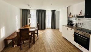 a kitchen with a table and a dining room at Appartement Weiss in Essing