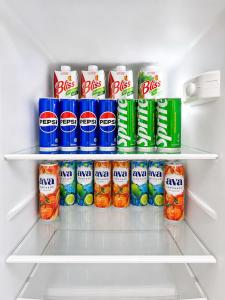 a refrigerator filled with lots of food and drinks at Cozy Apartment on the First Floor in Yunusobod