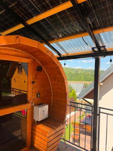 a wooden bird house on the balcony of a house at Glamping Bieszczadzki Amor in Zawóz