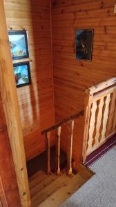 a staircase in a log cabin with two windows at ApartmanMN in Žabljak