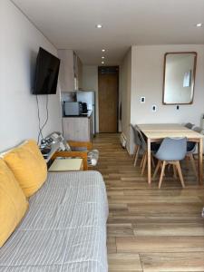 a living room with a couch and a table at Departamento dentro del centro de sky Valle de Las Leñas, Edificio Esparta in Las Lenas