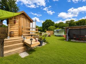 a wooden cabin in a yard with a tent at La Tiny de Lili in Draveil +12 photos