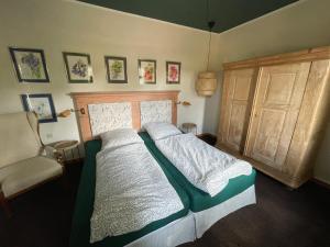 a bedroom with a bed and a chair in it at Prinzenvilla in Berge +18 photos