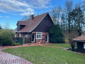 a house with a gambrel roof and a yard at Prinzenvilla in Berge