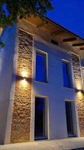 a white building with lights on the side of it at San Lorenzo Suite in Tigliole