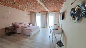a bedroom with a bed and a table and a table sidx sidx sidx at San Lorenzo Suite in Tigliole