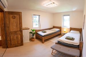 a bedroom with two beds and a window at Drevenička Levanduľa in Liptovská Kokava