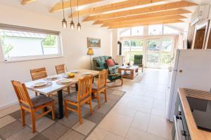 a kitchen and dining room with a table and chairs at Drevenička Levanduľa in Liptovská Kokava