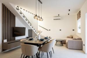 a dining room with a table and chairs and a couch at Stone house Mia in Čara