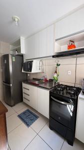 a kitchen with a stove and a refrigerator at Prive in Paulista