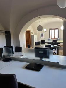 an office with tables and chairs in a room at Numa Living in Rapone