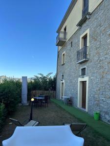 a patio with a table and chairs next to a building at Numa Living in Rapone