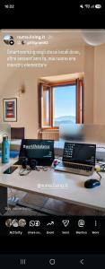 a desk with a laptop and a computer on it at Numa Living in Rapone