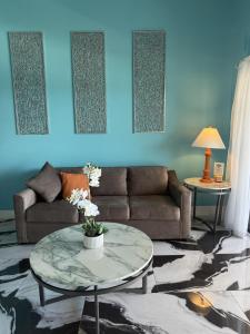 a living room with a couch and a table at Spacious 2BR Retreat • Balcony Views + Parking in Nazareth