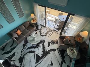 a living room with a fish painted on the floor at Spacious 2BR Retreat • Balcony Views + Parking in Nazareth