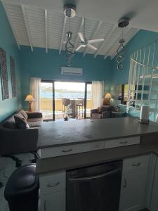 a kitchen with a living room with a view of the ocean at Spacious 2BR Retreat • Balcony Views + Parking in Nazareth