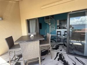 a balcony with a table and chairs and a staircase at Spacious 2BR Retreat • Balcony Views + Parking in Nazareth +20 photos
