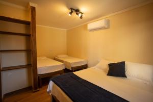 a room with two beds and a bunk bed at Maré Alta - Guest House in Ilha do Mel +45 photos