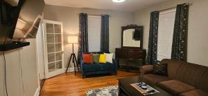 a living room with a couch and a mirror at The Stirton House in Shelburne
