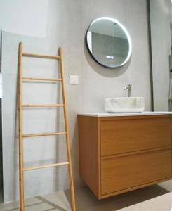 a bathroom with a sink and a ladder next to a mirror at Hundred Noons in Khandrinós +11 photos