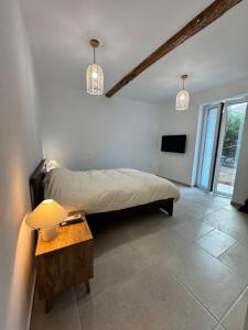 a bedroom with a bed and a table with a lamp at Hundred Noons in Khandrinós