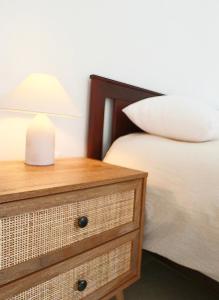 a bedroom with a bed and a nightstand with a lamp at Hundred Noons in Khandrinós