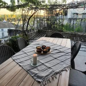 a table with a candle and some muffins on it at La Villa Regula in La Réole