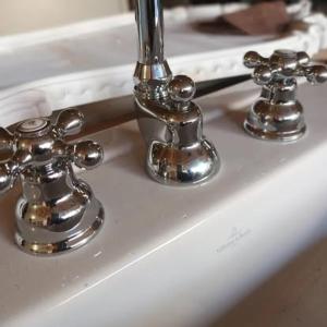 a bathroom sink with a chrome bathroom faucet at La Villa Regula in La Réole
