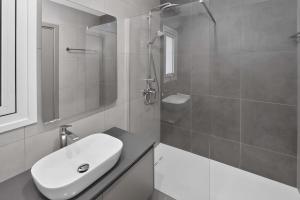 a white bathroom with a sink and a shower at Sun & Moon Luxury - Eclipse Villa in Ayia Napa +10 photos