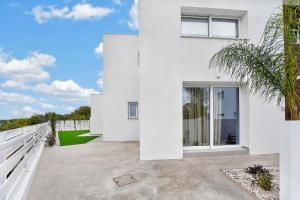a white house with a large patio at Sun & Moon Luxury - Eclipse Villa in Ayia Napa
