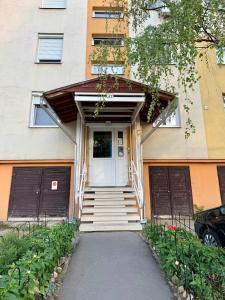a house with two garage doors and a driveway at 2-6 Apartman Szeged in Szeged